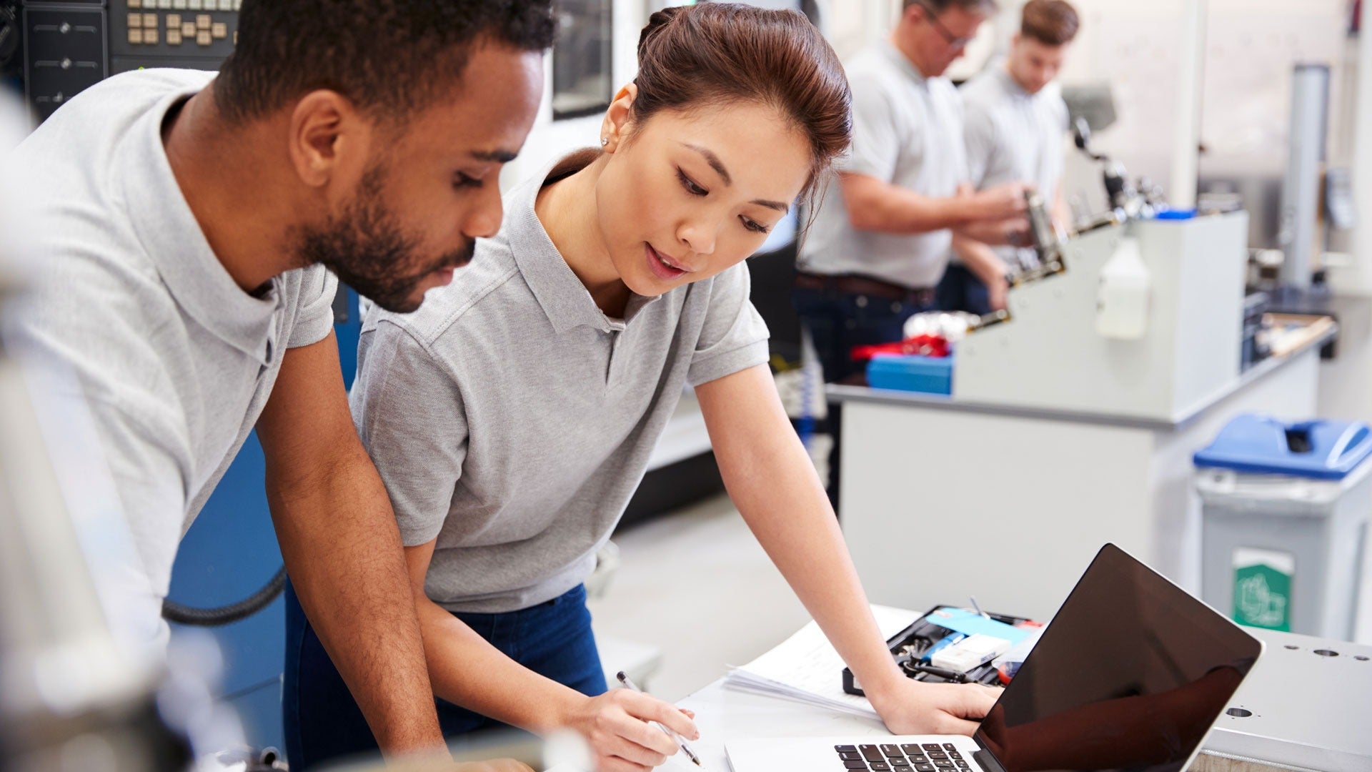 Two individuals looking at computers